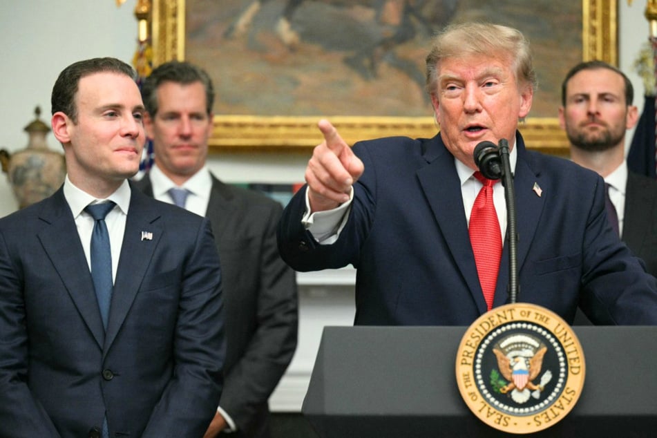 President Trump (r) on Wednesday hosted crypto executives at the White House as he faces criticism for making billions off the industry while in office.
