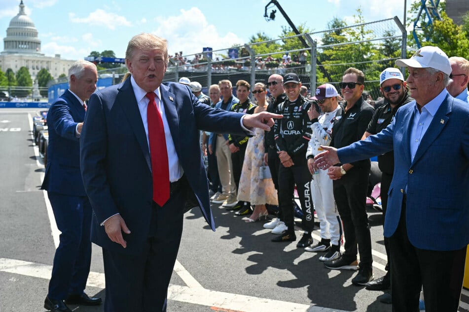 Trump greeted IndyCar series owner Roger Penske (r) ahead of Sunday's Grand Prix.