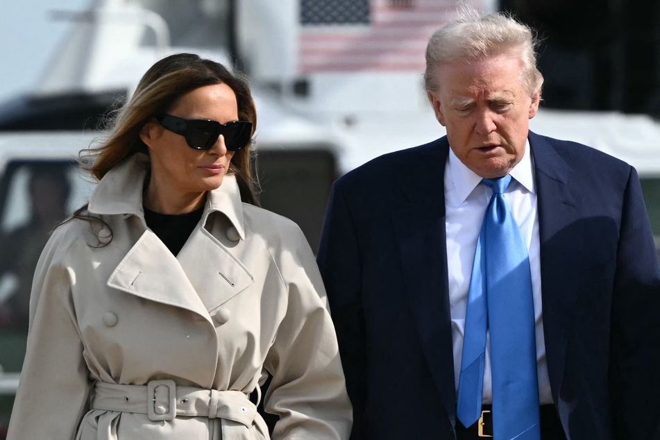 President Donald Trump (r.) and First Lady Melania Trump make their way to board Air Force One before departing from Joint Base Andrews in Maryland on April 25, 2025.