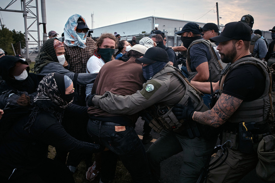 Federal agents grab and push protestors during a demonstration against federal immigration raids at Delaney Hall in Newark, New Jersey, on June 13, 2025.