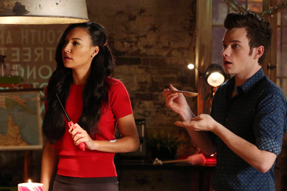 Naya Rivera (l.) and Chris Colfer starred on Glee as Santana Lopez and Kurt Hummel, respectively. Rivera passed away in 2020 – five years after the show originally ended.