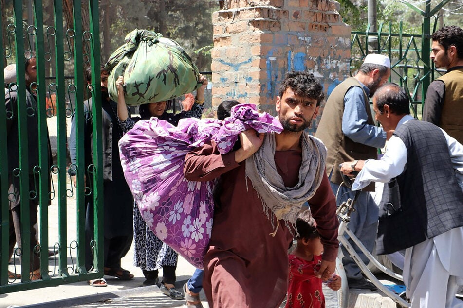 People depart their homes after the Taliban entered Kabul.