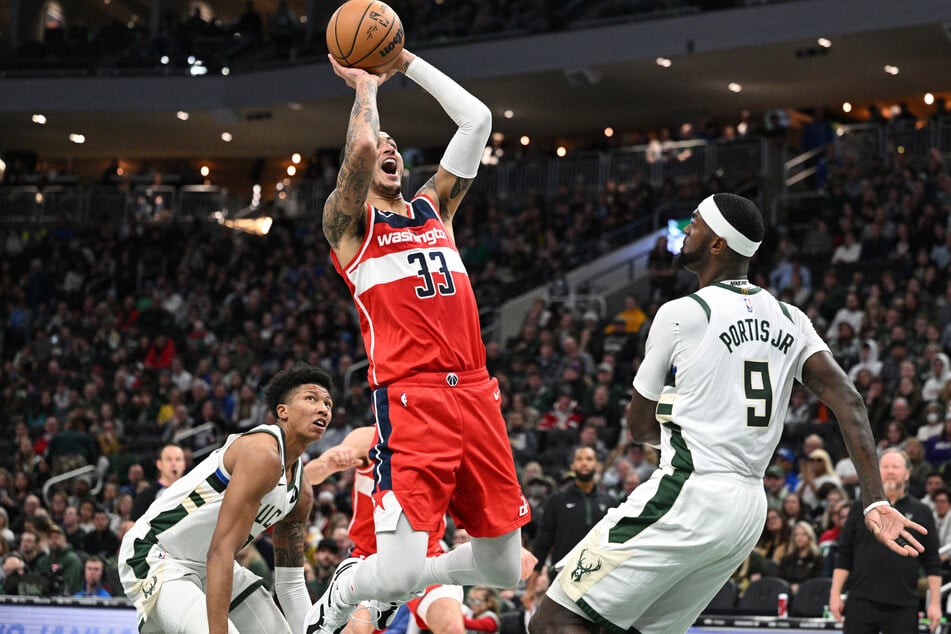 Washington Wizards forward Kyle Kuzma shoots the ball over Milwaukee Bucks forward Bobby Portis in the first half at Fiserv Forum.