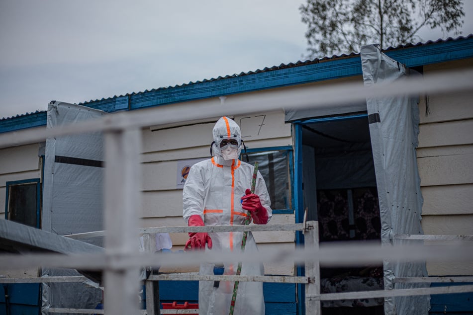 A hygienist wearing personal protective equipment begins cleaning and disinfection operations at the Rwampara Ebola Treatment Center in Bunia, Ituri, in the east of the Democratic Republic of Congo.