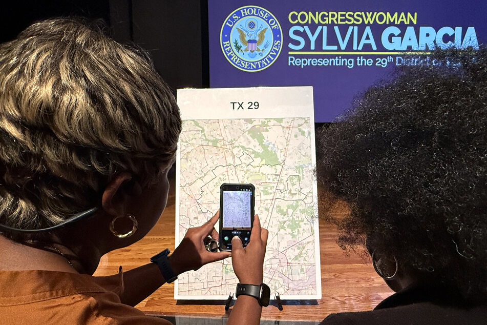 Voters look at a map to understand the new redistricting lines approved by Texas lawmakers for the 2026 midterm elections, at San Jacinto College in Houston on August 27, 2025.