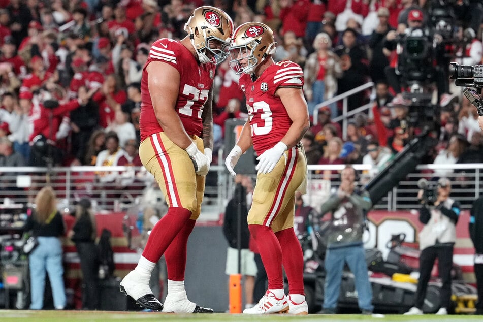 San Francisco 49ers running back Christian McCaffrey (r.) celebrates with offensive line Dominick Puni (l.) after scoring a touchdown during the second quarter against the Washington Commanders at Levi's Stadium.