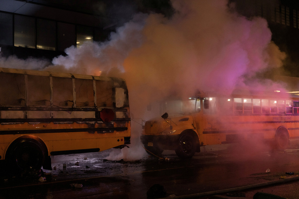 A fire on a shuttle bus, used to transport spectators for 2026 FIFA World Cup, is extinguished outside the Port Authority Bus Terminal in New York amid celebrations over the Knicks' NBA championship win on June 14, 2026.