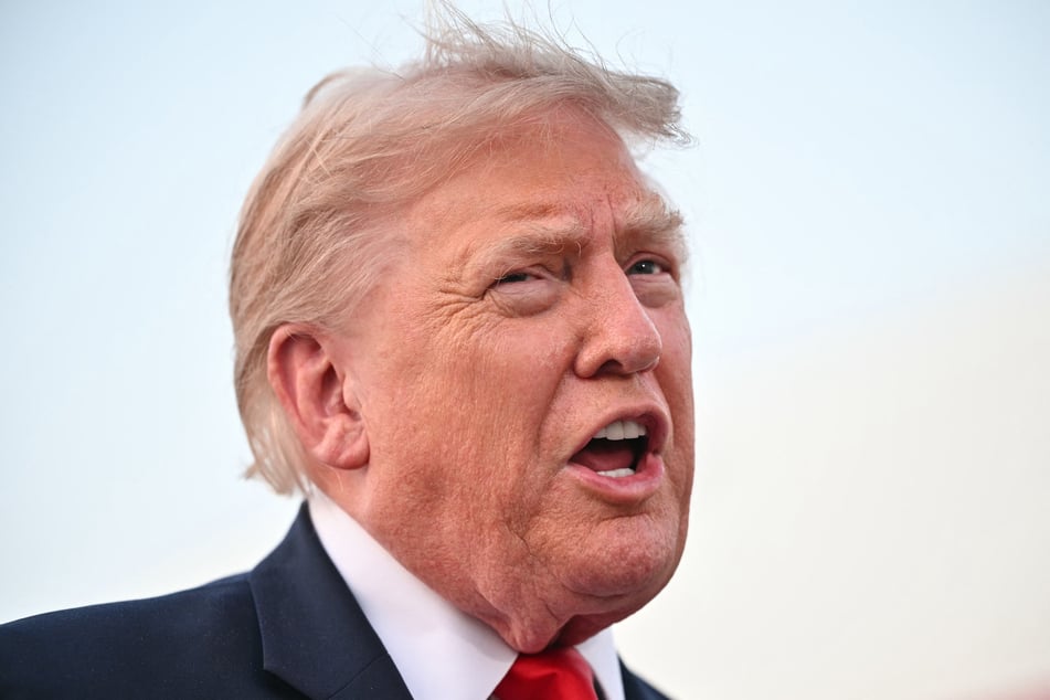 MANDEL NGAN / AFPPhoto by MANDEL NGAN / AFP US President Donald Trump speaks to reporters after stepping off Air Force One upon returning to Joint Base Andrews in Maryland on July 19, 2026.