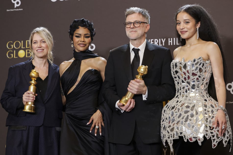 From l. to r.: Sara Murphy, Teyana Taylor, Paul Thomas Anderson, and Chase Infiniti pose with the Best Motion Picture - Musical or Comedy award for One Battle After Another at the 83rd Annual Golden Globes.