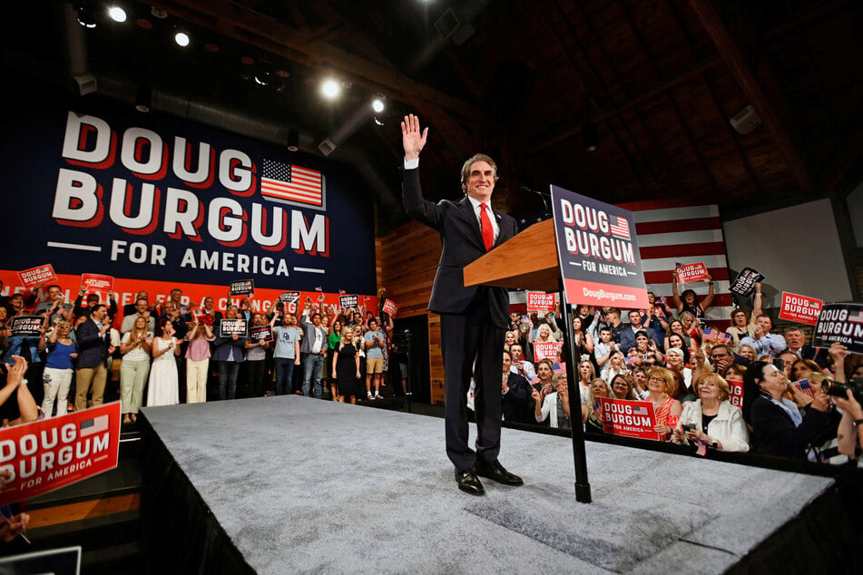 North Dakota Governor Doug Burgum waves to the crowd at an event in Fargo to announce his 2024 campaign for president.