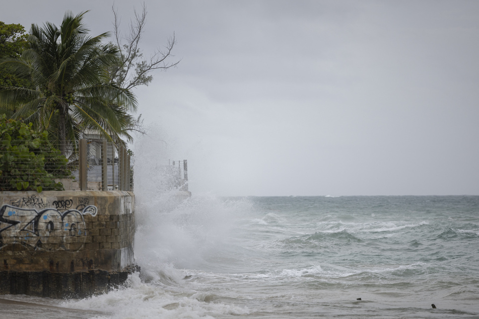Hurricane Erin downgraded to Category 3 as it lashes the Caribbean with rain