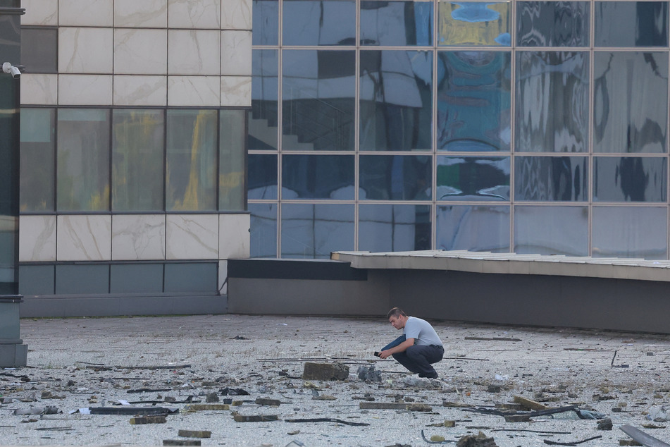 Debris litters the streets in the aftermath of a Ukranian drone attack on an office bloc in Moscow's business district.