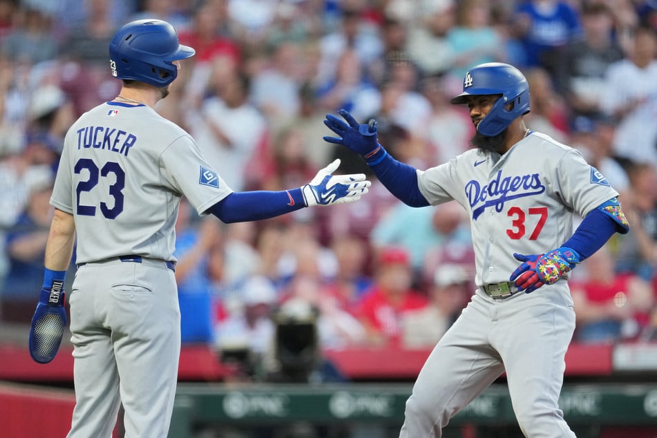 Teoscar Hernández of the Los Angeles Dodgers celebrates with teammate Kyle Tucker after hitting a two-run home run during the fourth inning against the Cincinnati Reds on September 14, 2026. With their win, the Dodgers secured their spot in the MLB playoffs.