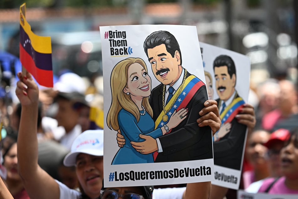 Supporters of Venezuela's ousted President Nicolas Maduro demonstrate with a poster of him and his wife, Cilia Flores, reading "We want them back" in Caracas on March 26, 2026. Flores has requested she be released from New York detention and placed under house arrest.