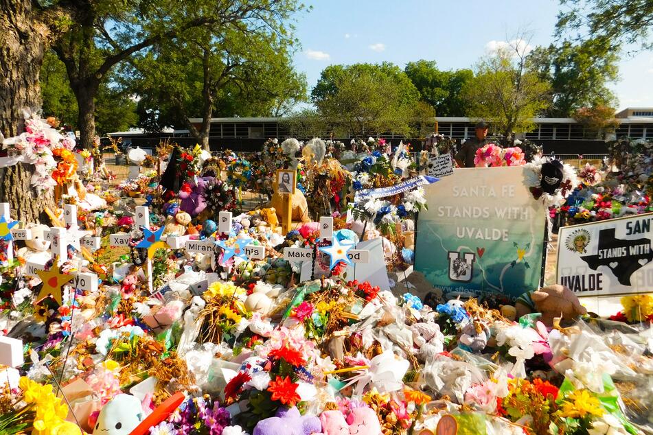Flowers and toys are placed at a memorial outside Robb Elementary in Uvalde.