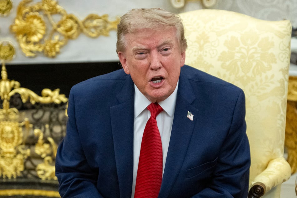 President Donald Trump (pictured) speaks as he meets with lifeguard Ryder Williams in the Oval Office of the White House in Washington, DC, on Monday.