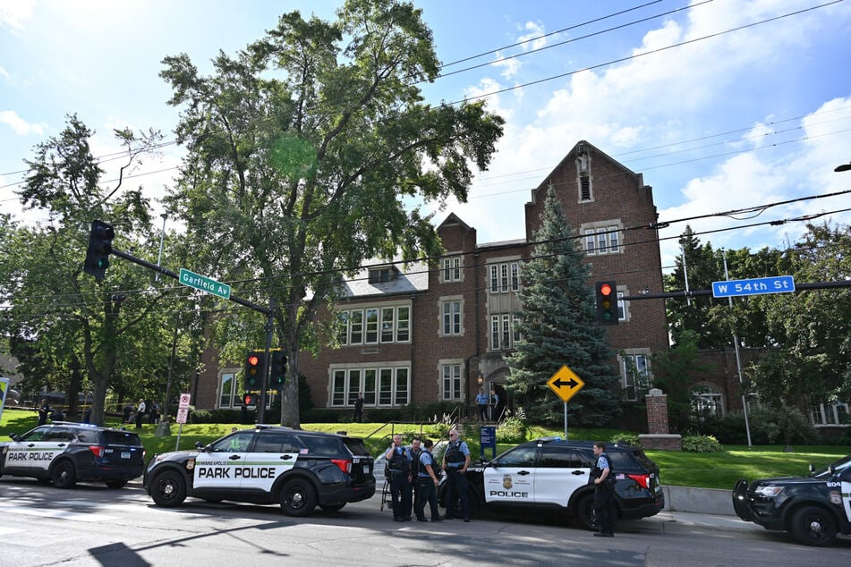 Police and first responders work at the scene of a shooting near Annunciation Church and Catholic School in Minneapolis, Minneosta, on Wednesday.