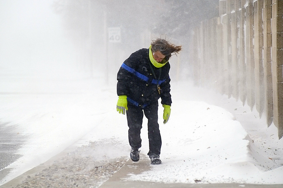 Albuquerque, New Mexico: a woman struggles to keep her balance amid frigid temperatures, snow and winds.