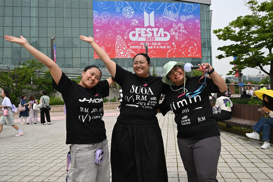 Fans of K-pop band BTS pose for photos as they attend the annual BTS Festa celebrating the group's debut anniversary at KINTEX exhibition center in Goyang, South Korea, on June 13, 2025.