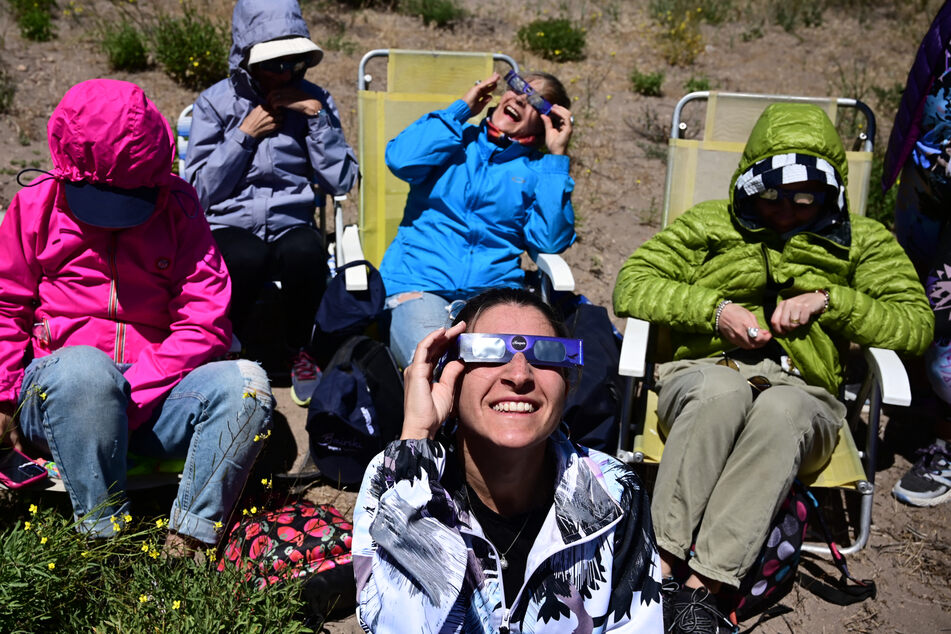 The total solar eclipse often brings people together as they collectively view the rare event.