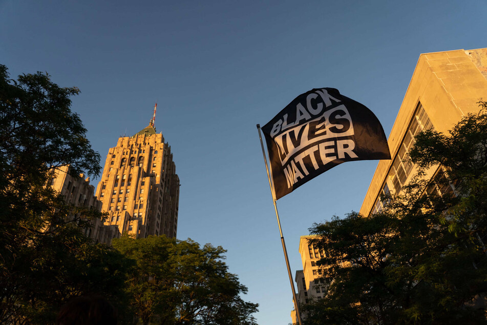 A Black Lives Matter flag waves in the air in Downtown Detroit.