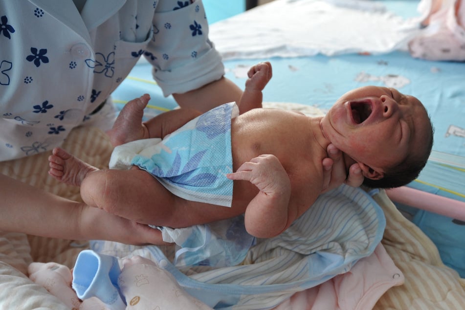 A nurse takes care of a newborn baby at a hospital in Fuyang, in China's eastern Anhui province, on January 17, 2023.