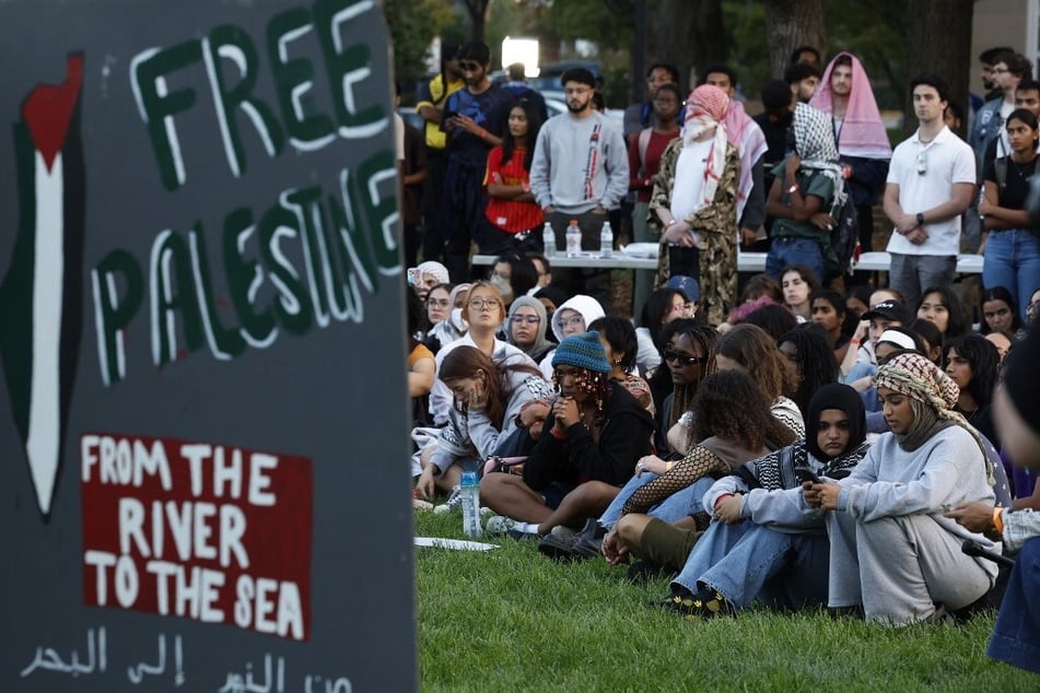 Attendees gather for a vigil organized by the Students for Justice in Palestine along McKeldin Mall in the heart of the University of Maryland campus in College Park.