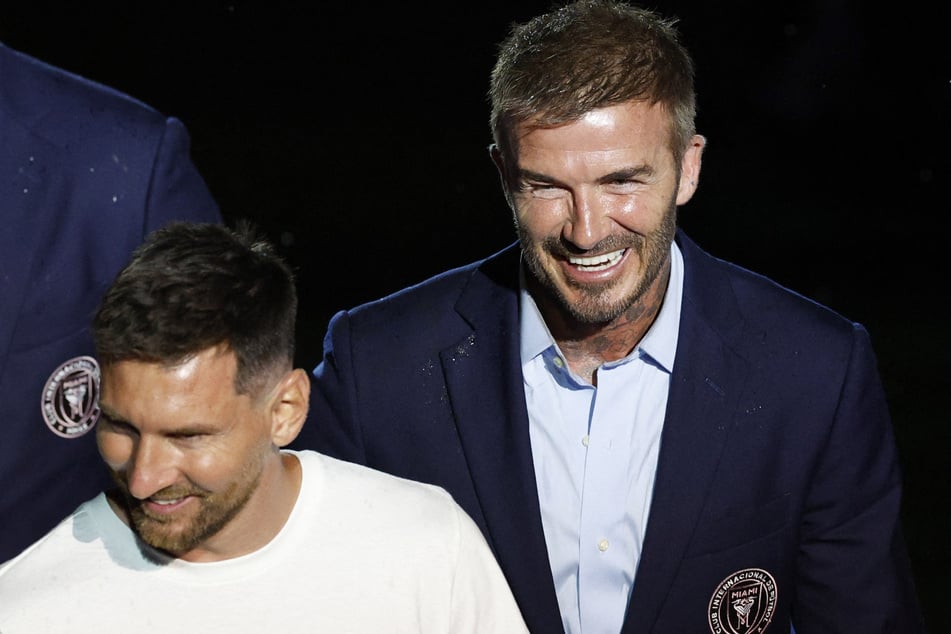 New Inter Miami signing Lionel Messi stands beside owner David Beckham during the unveiling.