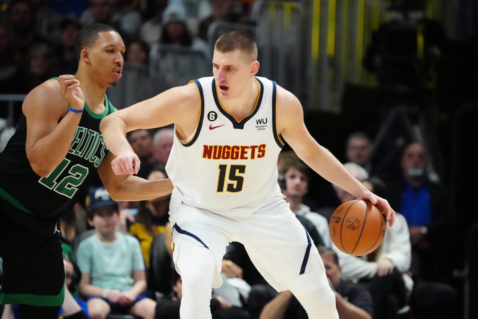 Denver Nuggets center Nikola Jokic drives the ball at Boston Celtics forward Grant Williams in the second half at Ball Arena.