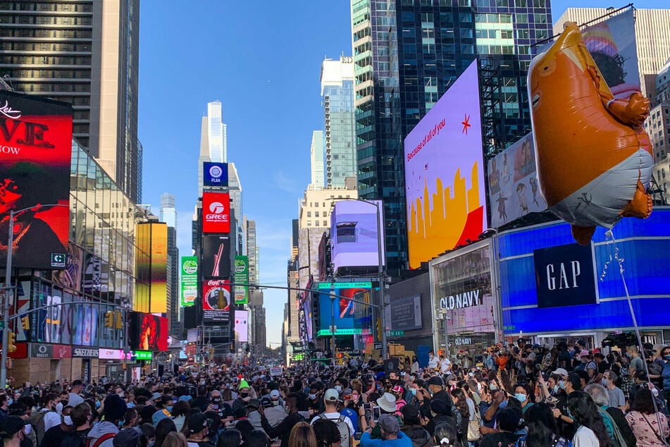People gather in Times Square after Democratic nominee Joe Biden is confirmed as the winner of the presidential election.