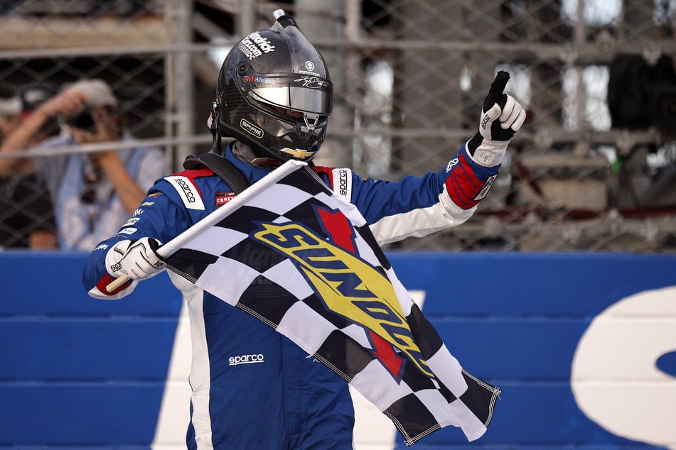 Kyle Busch celebrates with the checkered flag after winning the NASCAR Craftsman Truck Series ECOSAVE 200 at Dover Motor Speedway in Delaware on May 15, 2026.