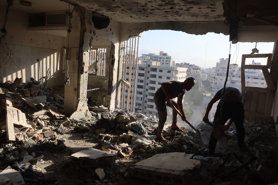 Palestinian residents salvage what they can from an apartment targeted in overnight Israeli airstrikes in Gaza City on August 2, 2026.