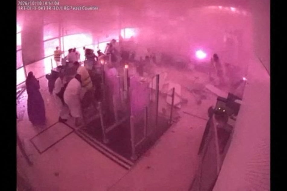 Surveillance footage shows smoke and fire as people react at the moment of an attack at King Khalid International Airport in Riyadh, Saudi Arabia, on October 10, 2026.