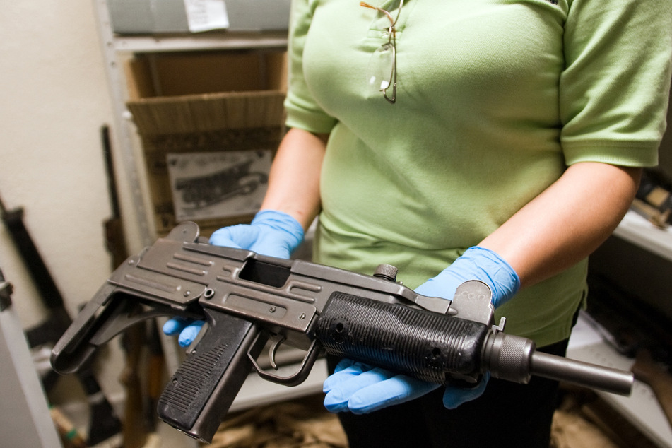 A criminologist shows a "Uzi" submachine gun used by local drug traffickers, at the Criminology Laboratory on May 28, 2008 in Ciudad Juarez, state of Chihuahua, north Mexico.