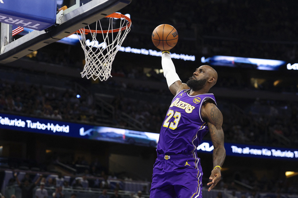 Los Angeles Lakers forward LeBron James drives to the basket against the Orlando Magic in the first quarter at Kia Center on March 21, 2026.