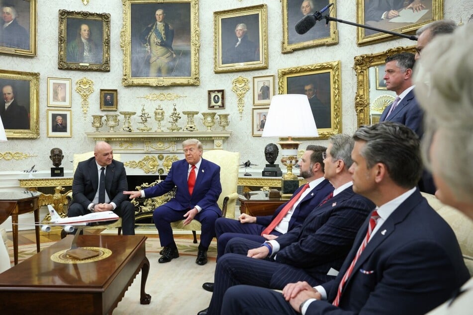 President Donald Trump (c) and members of his cabinet as he speaks with Lebanese President Joseph Aoun (l) during a meeting at the White House.