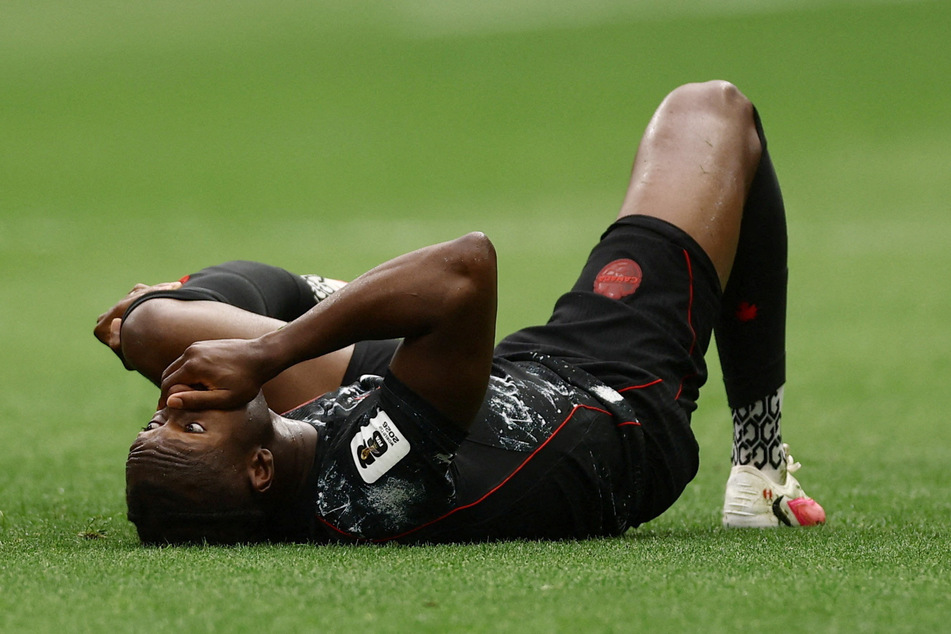 Canada's Ismael Kone lays on the ground after sustaining an injury during the World Cup Group B match against Qatar on June 18, 2026.