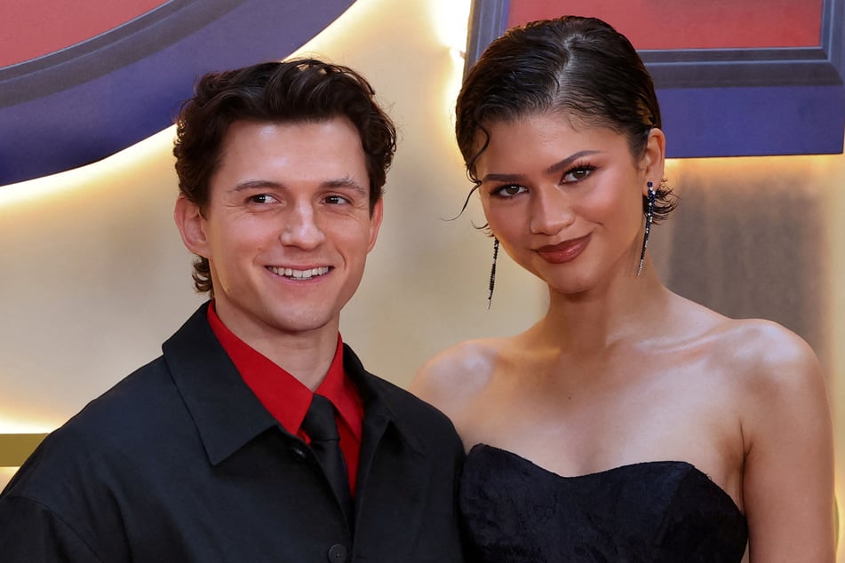 Tom Holland (l.) casually confirmed that he and Zendaya are indeed married as the lovebirds kicked off promotion for their upcoming movie, Spider-Man: Brand New Day.