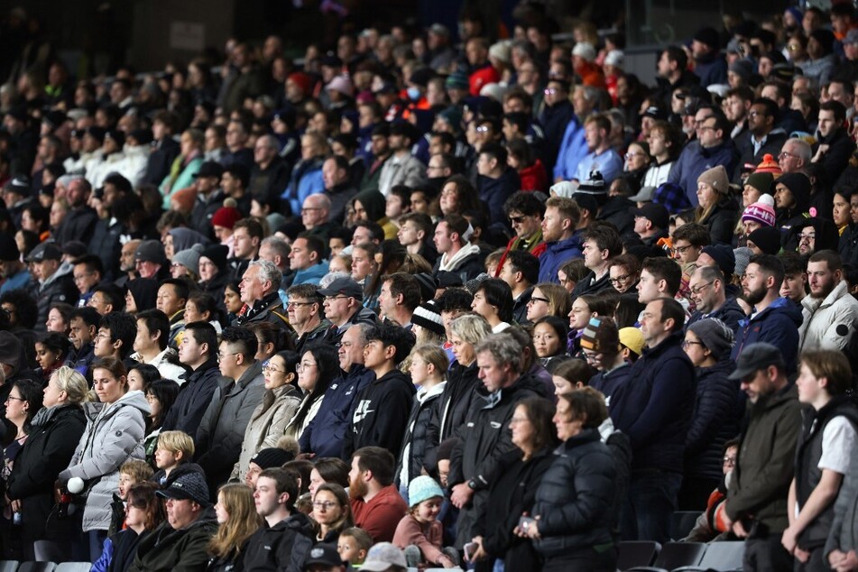 Fans observe a minute of silence for victims of a shooting in Auckland ahead of the New Zealand-Norway match.