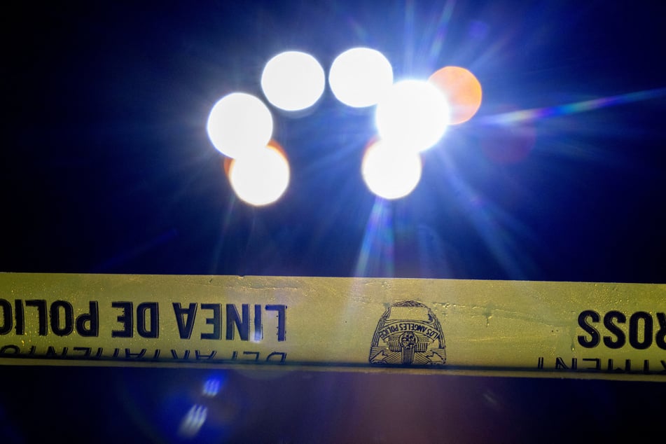 Police crime scene tape is used to cordon off the Brentwood Park neighborhood, after bodies of two people were found at the home of Hollywood director Rob Reiner in Los Angeles, California, on December 14, 2025.