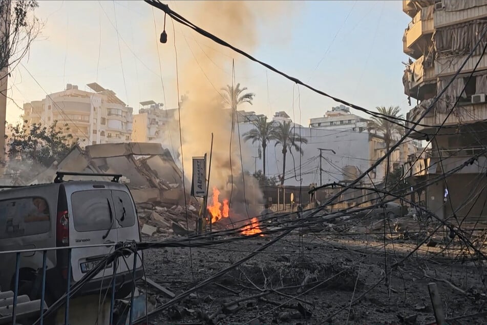 Smoke billows from a fire and buildings damaged after an early morning Israeli strike on Beirut's southern suburbs on March 3, 2026.