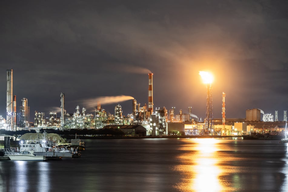 A flare stack burns off byproduct gasses at the Toa oil refinery in Kawasaki, Japan, on October 14, 2026.