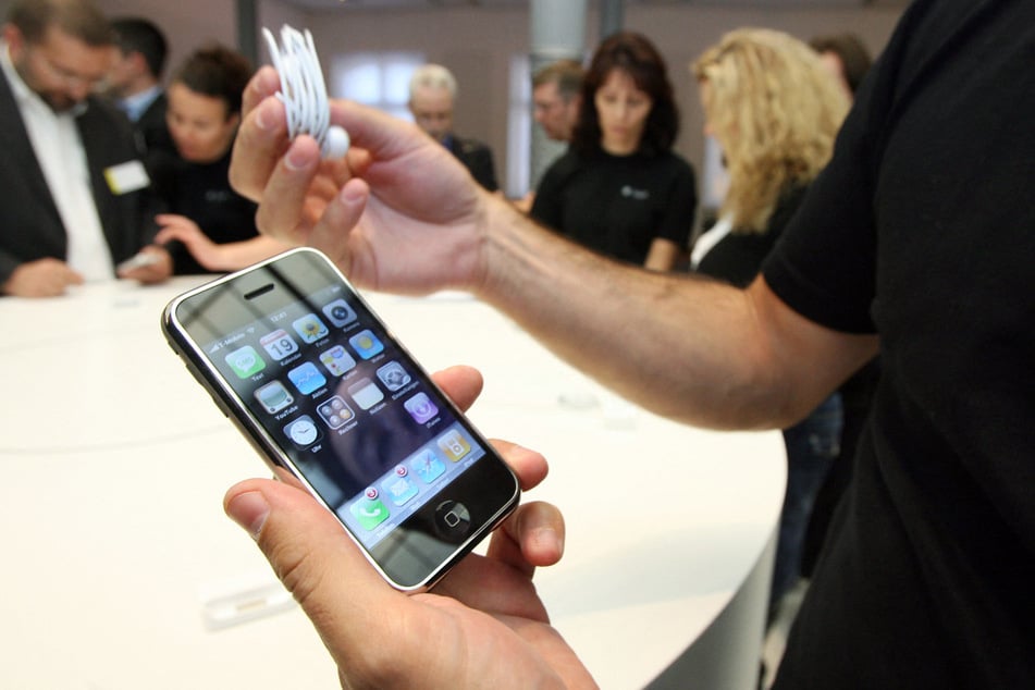An Apple employee explains the use of an iPhone during a press conference in September 2007 after the product was released in 2007.