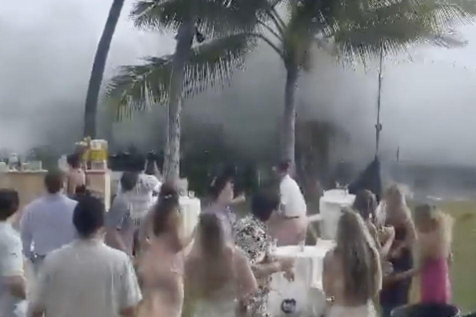 The guests of a wedding party witnessed a huge wave washing away tables and chairs.