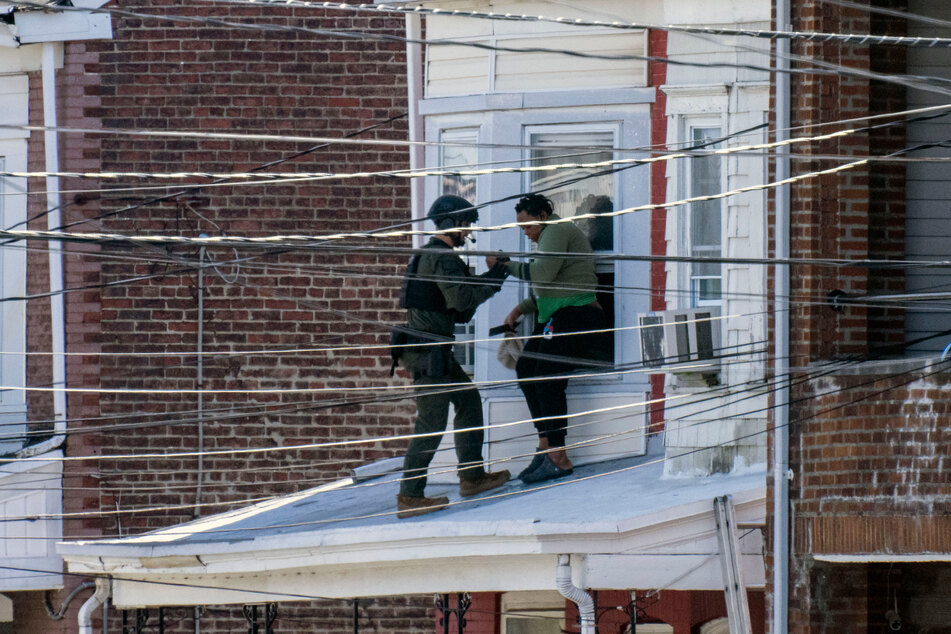 Police helped hostages evacuate from the home as the suspect barricaded himself inside.