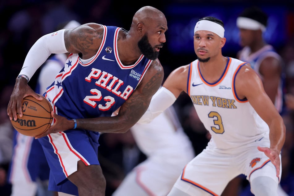 Philadelphia 76ers forward LeBron James (l.) controls the ball against New York Knicks guard Josh Hart (r.) during the first quarter at Madison Square Garden.