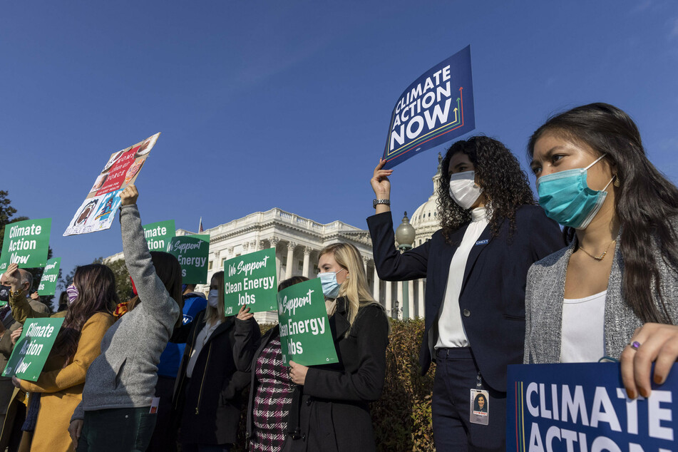 Climate activists gather outside the Capitol in support of the Build Back Better Act.