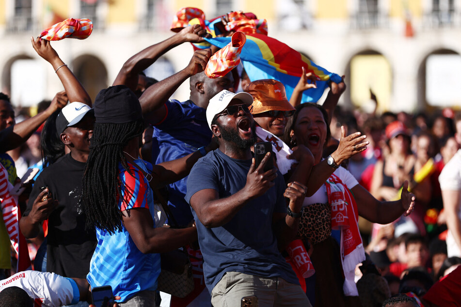 DR Congo fans in Lisbon, Portugal, celebrate their first goal scored by Yoane Wissa.