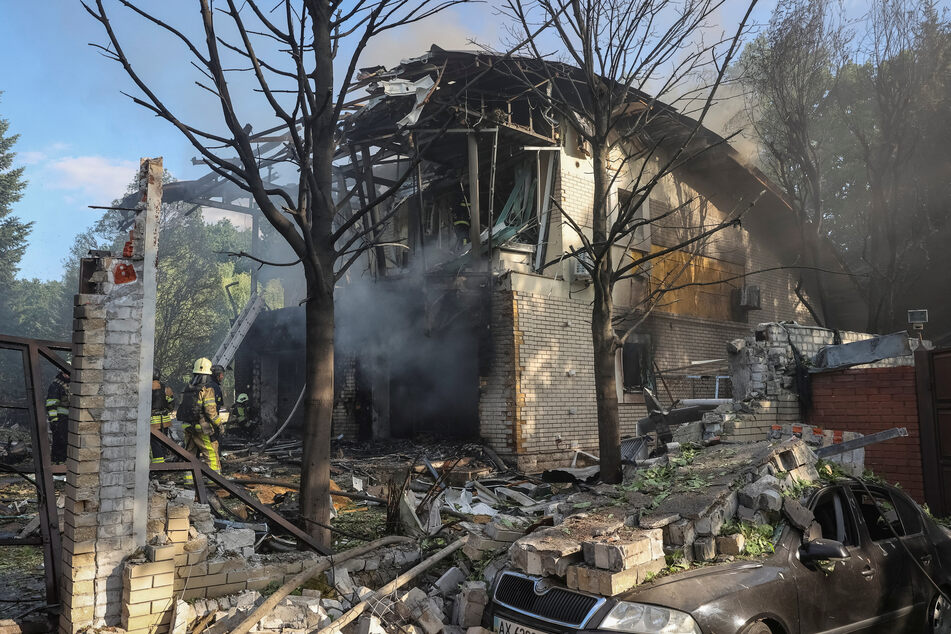 Firefighters work at a site of a private house, destroyed during a Russian missile attack, in Kharkiv, Ukraine.