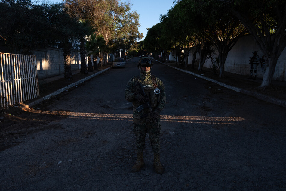 A member of Mexico’s Marines guards the area around the prosecutor's office after a drone attack the night before, in Playas de Tijuana, Baja California state, Mexico, on October 16, 2025.